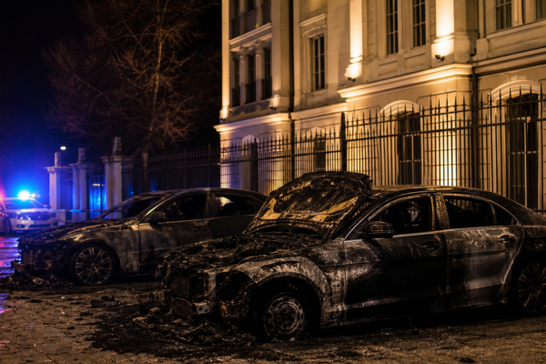 Дипломатическа сграда и автомобили след пожар през нощта